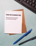 Note with message on a desk with a keyboard, pen, and crumpled paper.