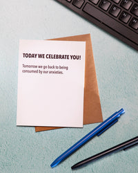 Note with message on a desk with a keyboard, pen, and crumpled paper.
