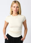 Woman wearing a white short-sleeve top and black pants on a white background