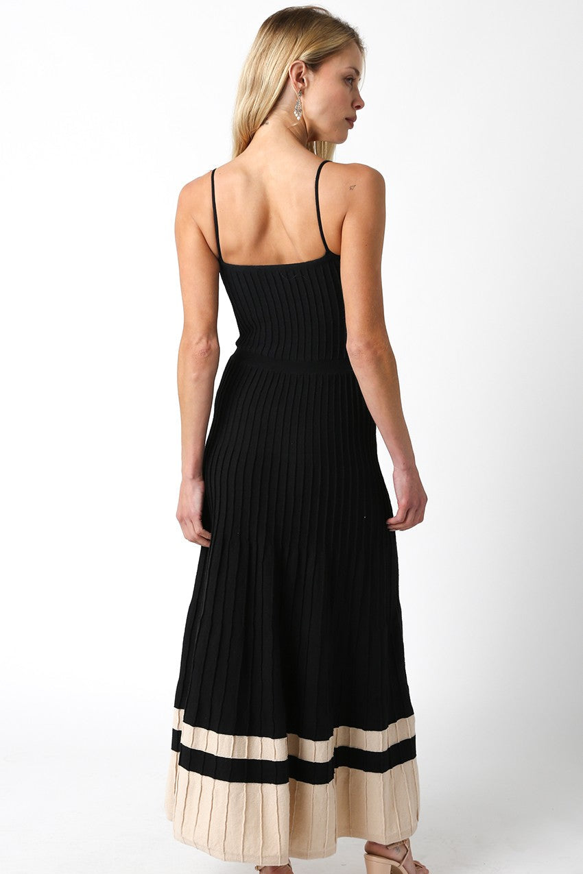 Woman wearing a black and beige dress on a white background