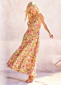 Woman wearing a floral dress against a plain background
