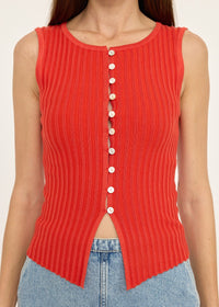 Red ribbed tank top with button details worn by a person, against a neutral background