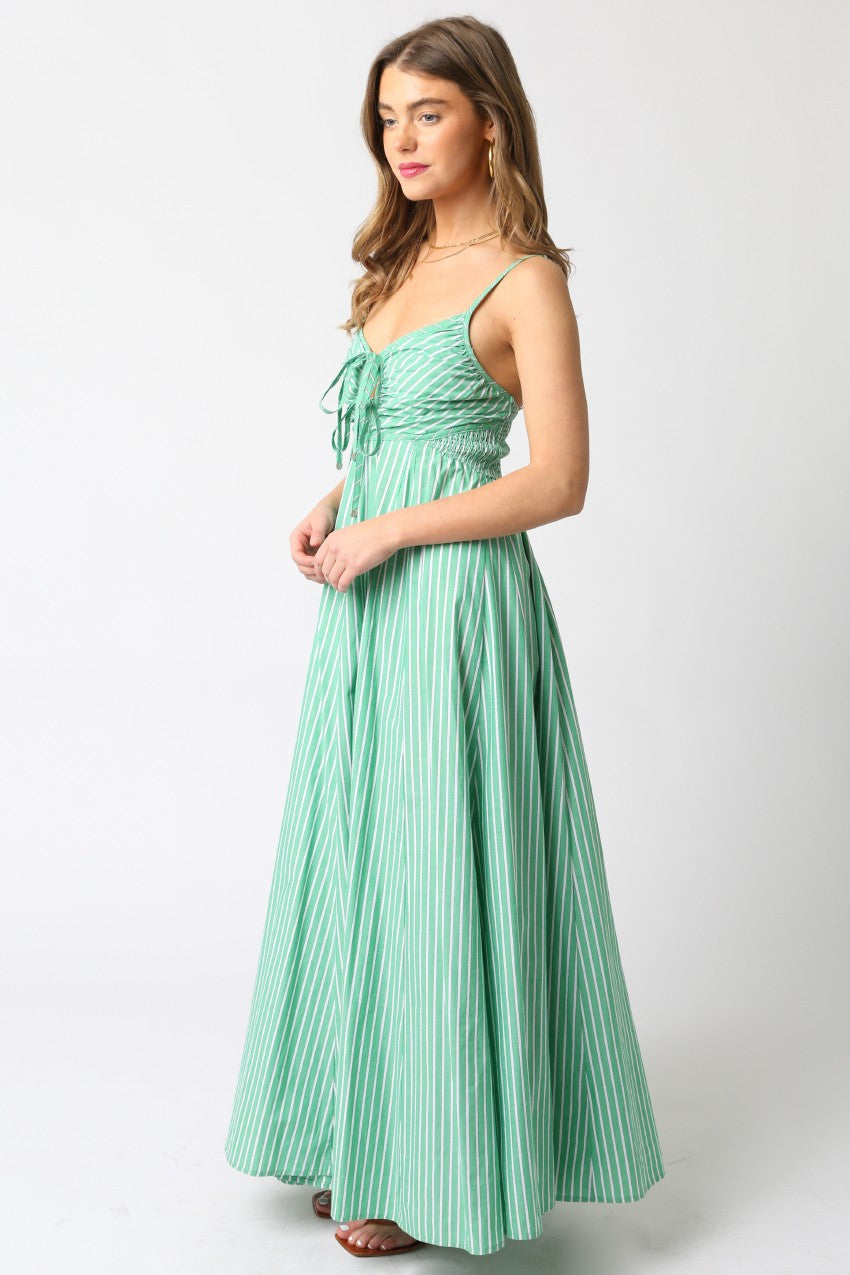 Woman wearing a green striped dress on a white background