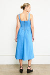 Woman wearing a blue dress with a white background