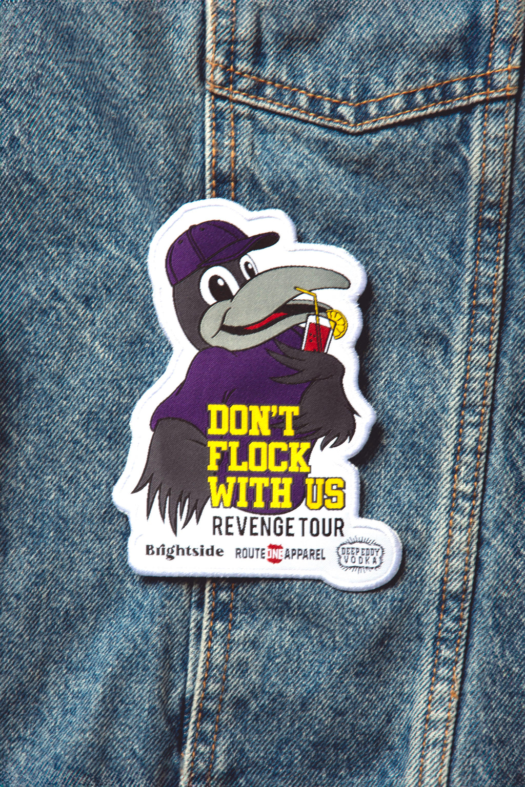 A patch with an illustration of a character holding a beer bottle and the text 'DON'T FLOCK WITH US' from the 'Brightside x R1A x Deep Eddy's' collection.