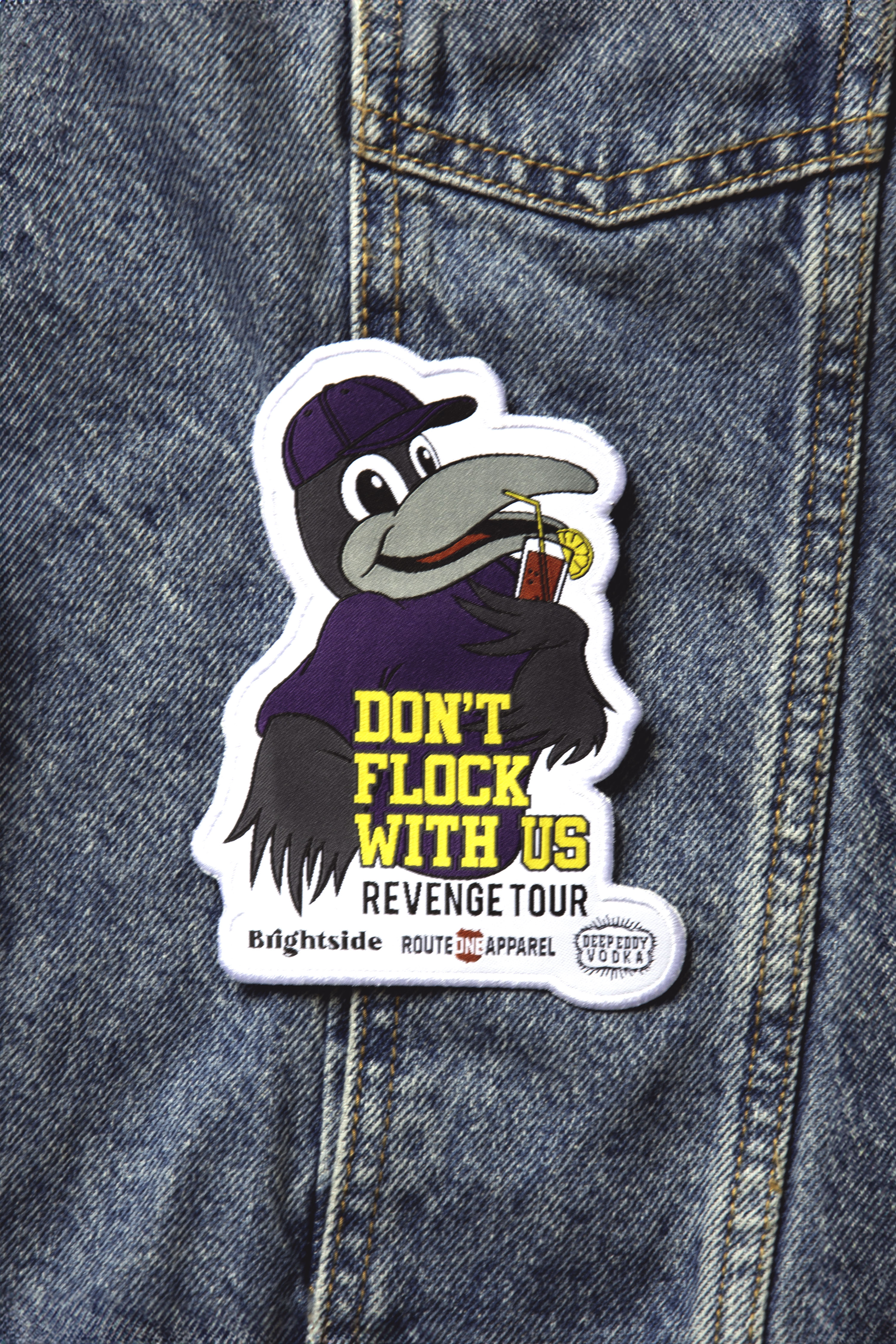 A patch with an illustration of a character holding a beer bottle and the text 'DON'T FLOCK WITH US' from the 'Brightside x R1A x Deep Eddy's' collection.