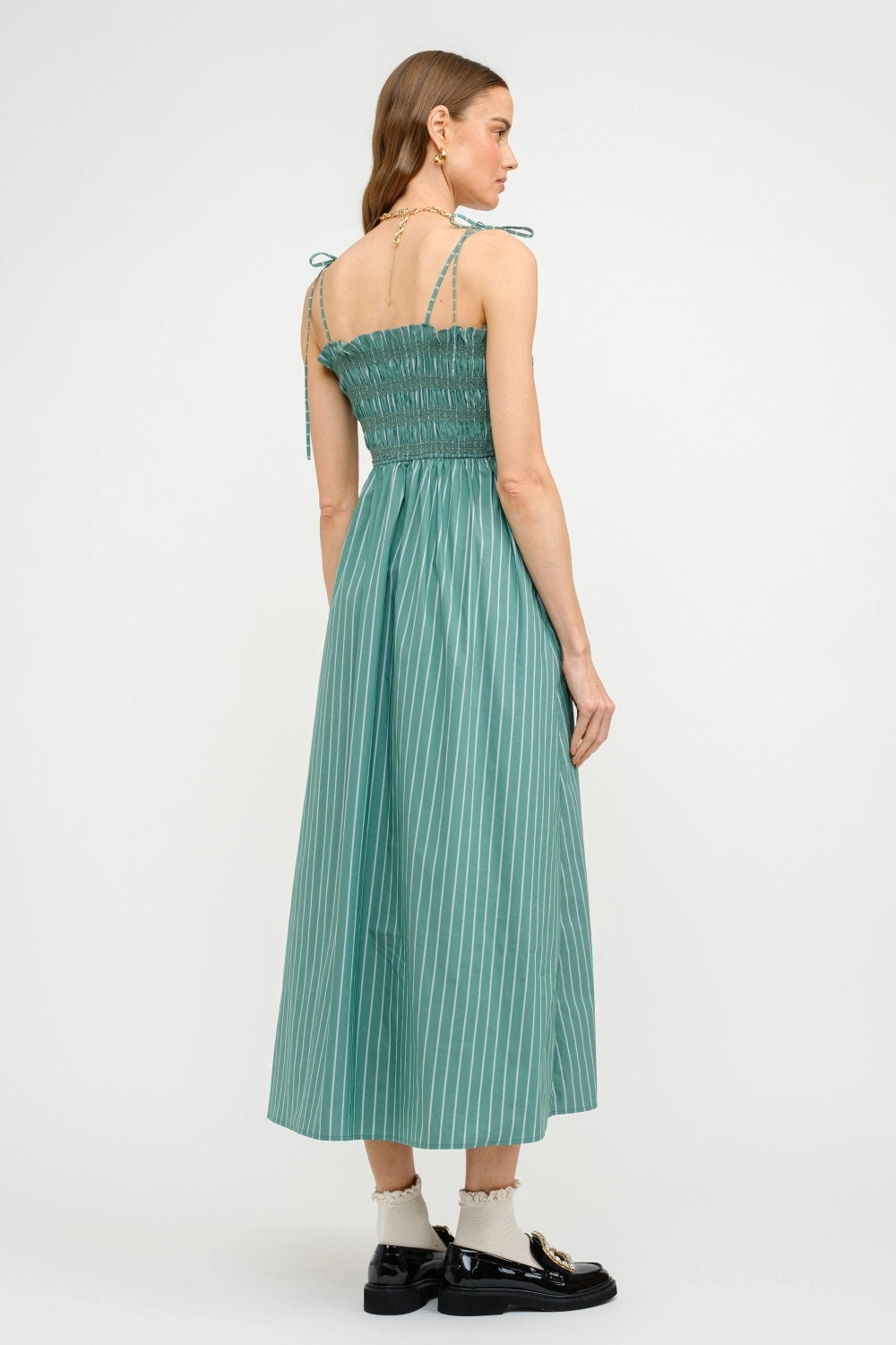 Woman wearing a green dress on a white background