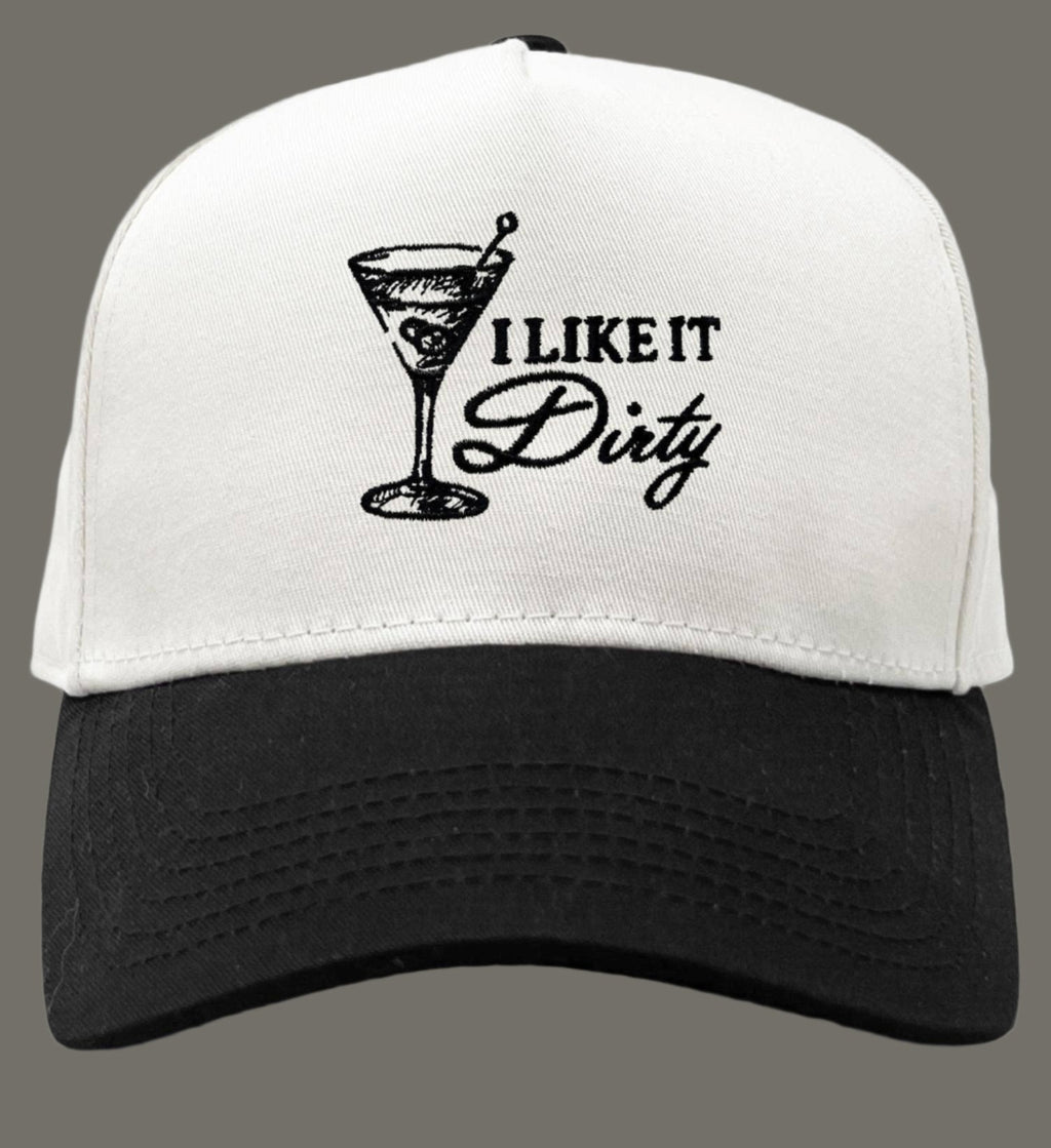 White and black cap with a martini glass design and text 'I Like It Dirty' on a white background