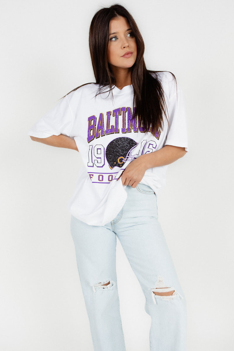 Step out on Game day in our Vintage Baltimore Football Tee! Support the Ravens Football team in your new game day gear. Pair a brami and Levi’s and you’re ready to go. Let’s go Ravens! A collection By Brightside